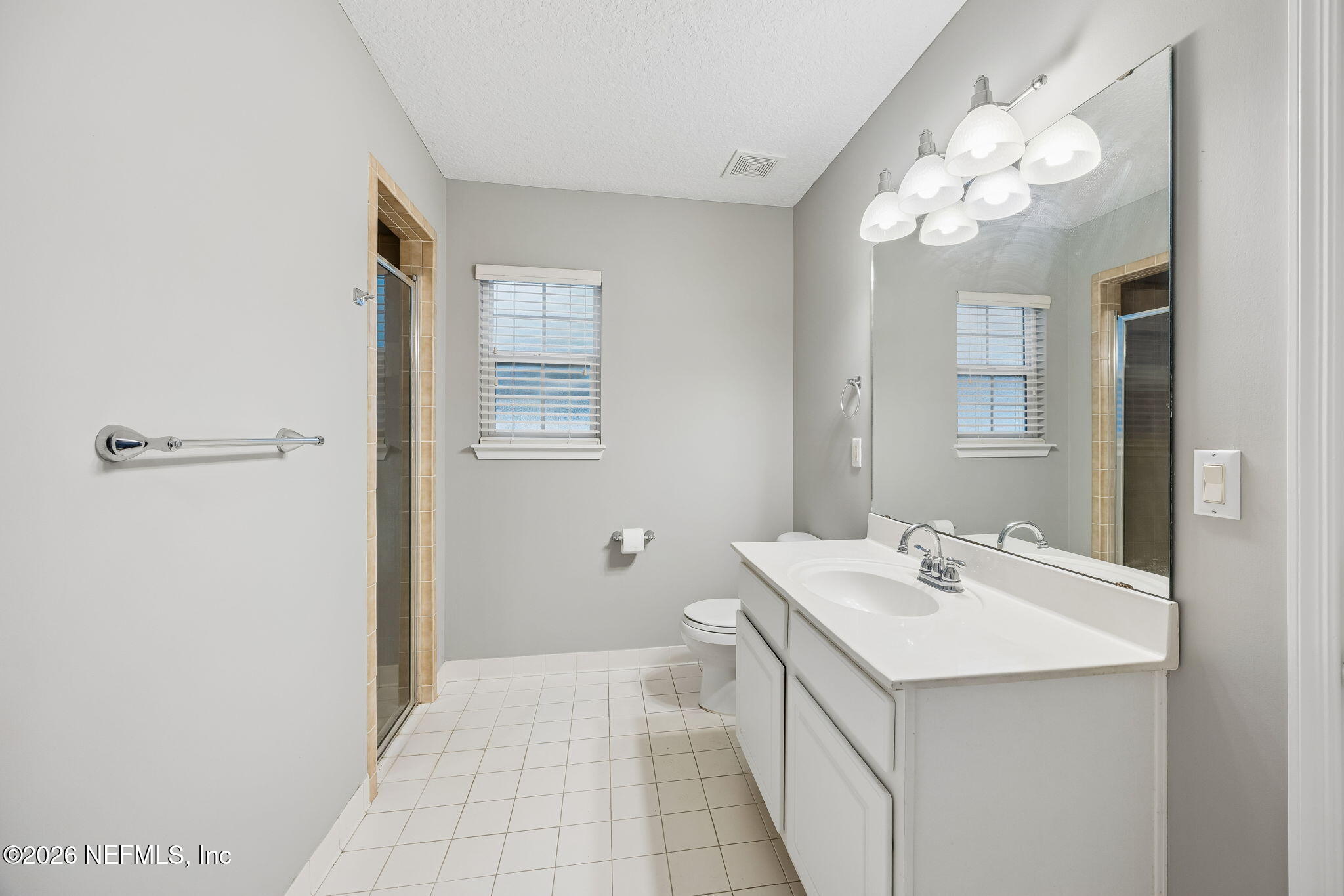 213 Springwood Lane St. Johns, FL 32259 - Photo 37 of 78 a bathroom with a sink a mirror and a shower