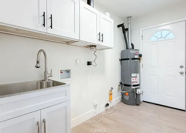 a kitchen with a sink and cabinets