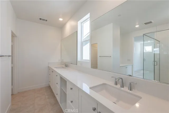 a bathroom with a granite countertop toilet sink and mirror