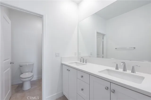 a bathroom with a sink toilet and mirror