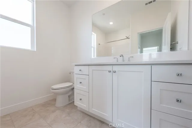a bathroom with a bathtub and toilet
