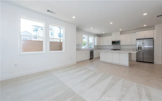 a view of a kitchen with white cabinets