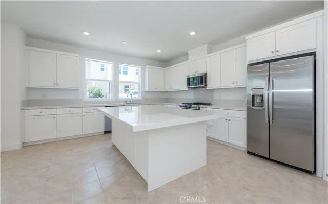 a kitchen with a sink stove cabinets and refrigerator