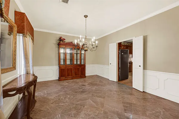 a view of a livingroom with a chandelier furniture and windows