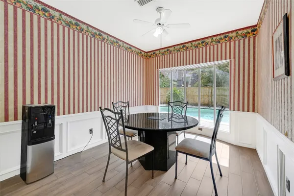 a kitchen with a wooden floor and a refrigerator