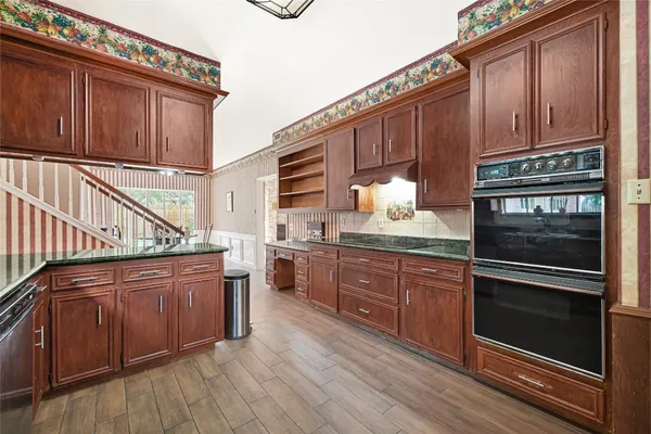 a kitchen with lots of counter top space and wooden floor