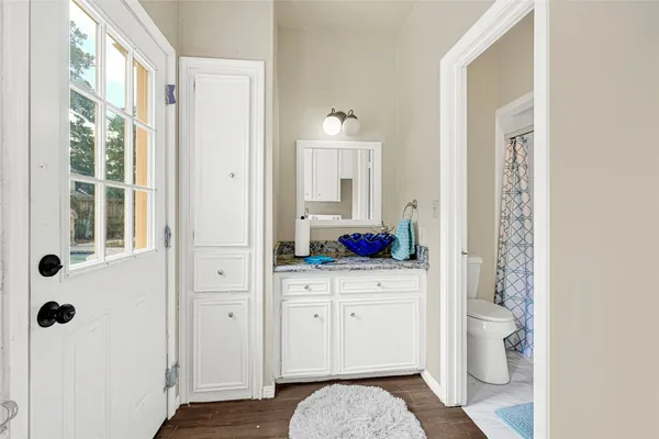 a bathroom with a shower curtain and a toilet