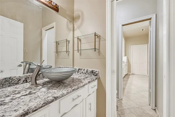 a bedroom with a large bed and a large window