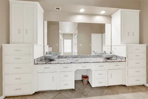 a bathroom with a glass shower door and a window