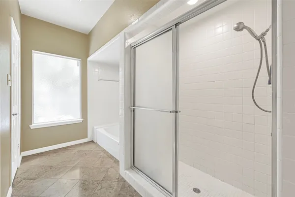 a bathroom with a bathtub and a shower