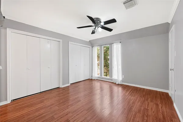 a en suite bathroom with a granite countertop sink and a mirror