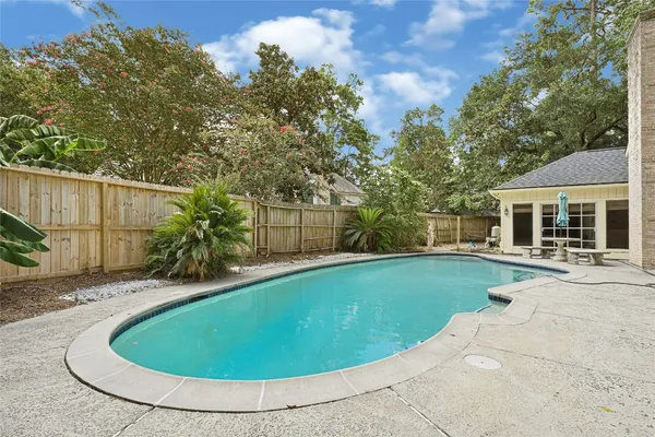 a front view of a house with a garden and yard
