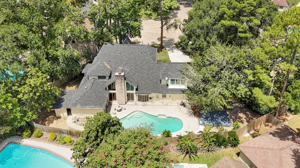 an aerial view of a house with yard