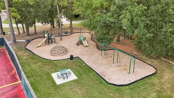a spacious bedroom with a bed a couch and a bookshelf