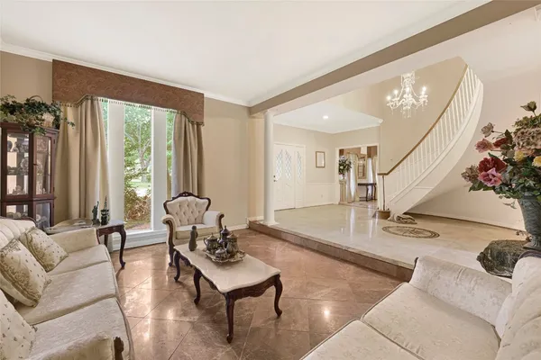 a living room with furniture and large windows