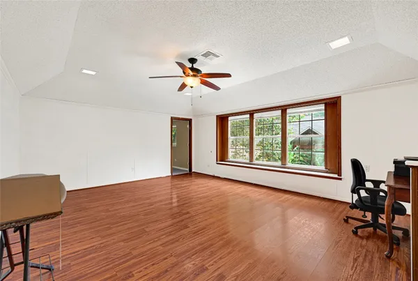 a view of workspace with wooden floor and a window