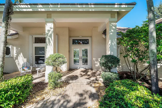 a living room with a large window and a rug
