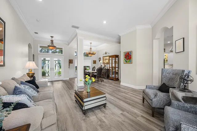 a view of a dining room with furniture wooden floor and chandelier