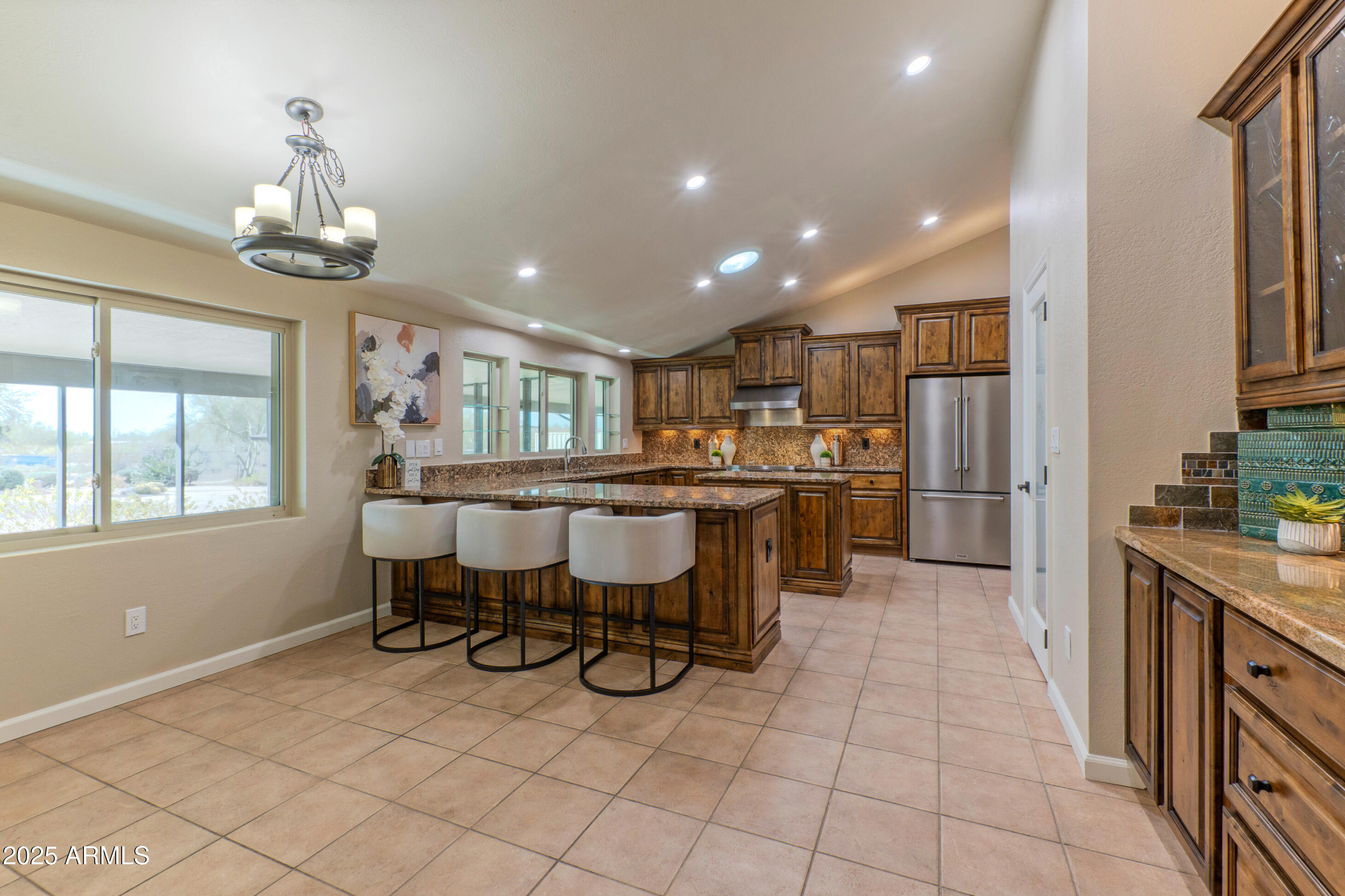 5911 East Peak View Road Cave Creek, AZ 85331 - Photo 16 of 63 a kitchen with stainless steel appliances kitchen island granite countertop a sink and cabinets
