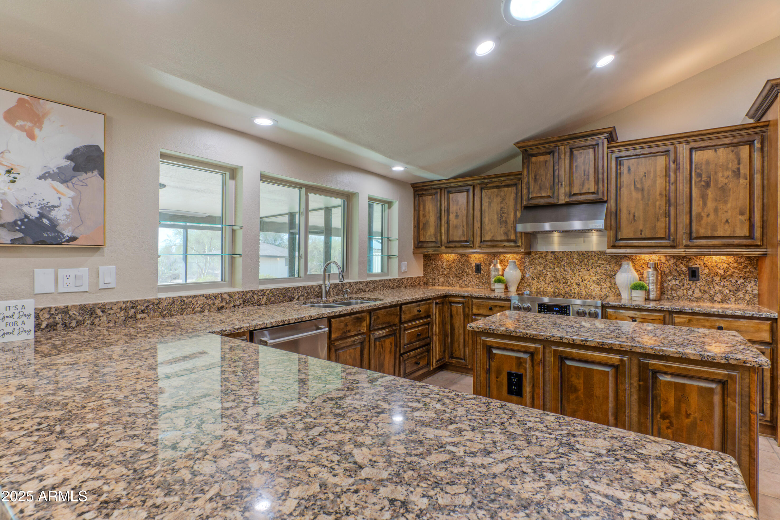5911 East Peak View Road Cave Creek, AZ 85331 - Photo 18 of 63 a kitchen with stainless steel appliances granite countertop a stove sink and cabinets