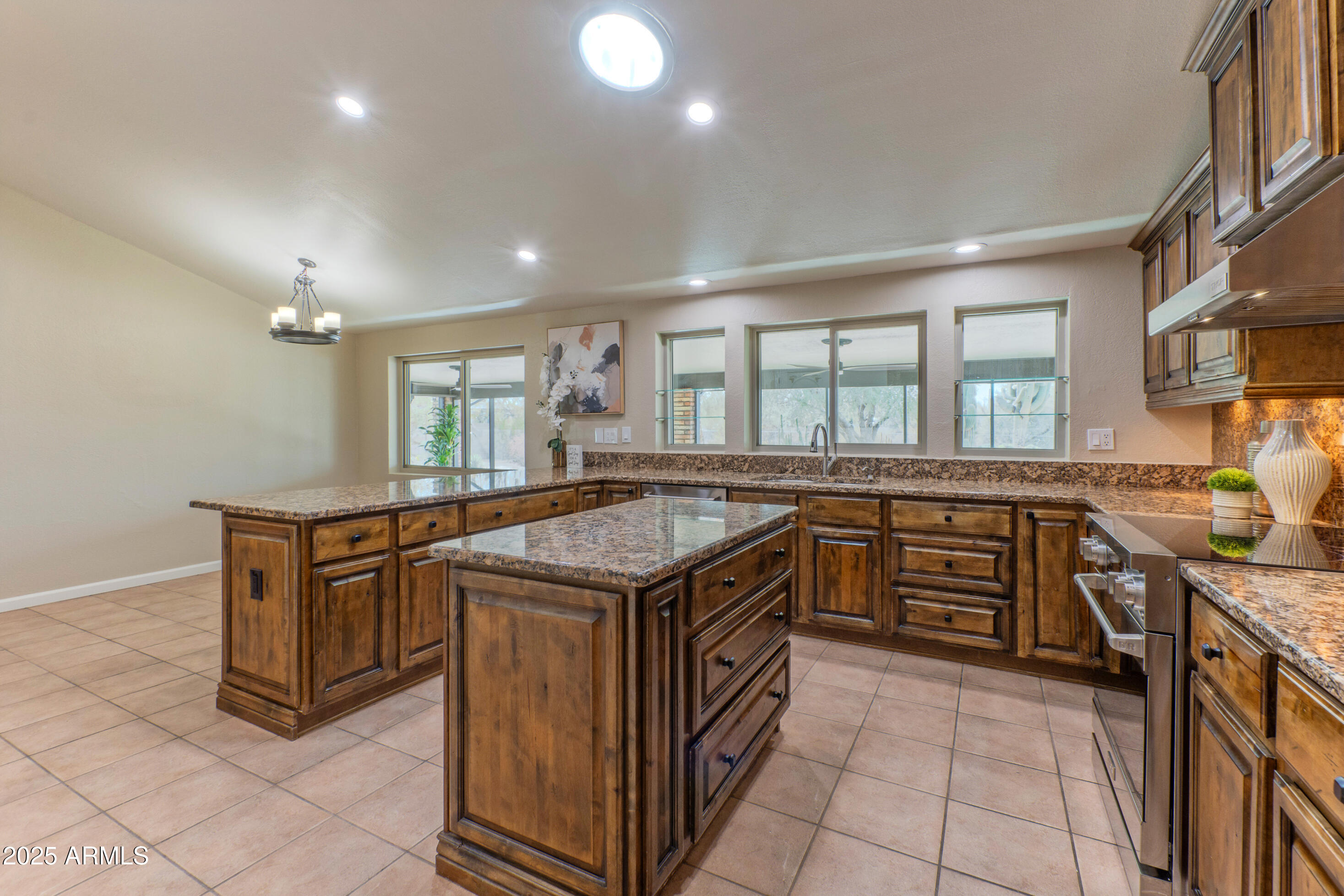 5911 East Peak View Road Cave Creek, AZ 85331 - Photo 19 of 63 a kitchen with stainless steel appliances granite countertop a stove and a sink