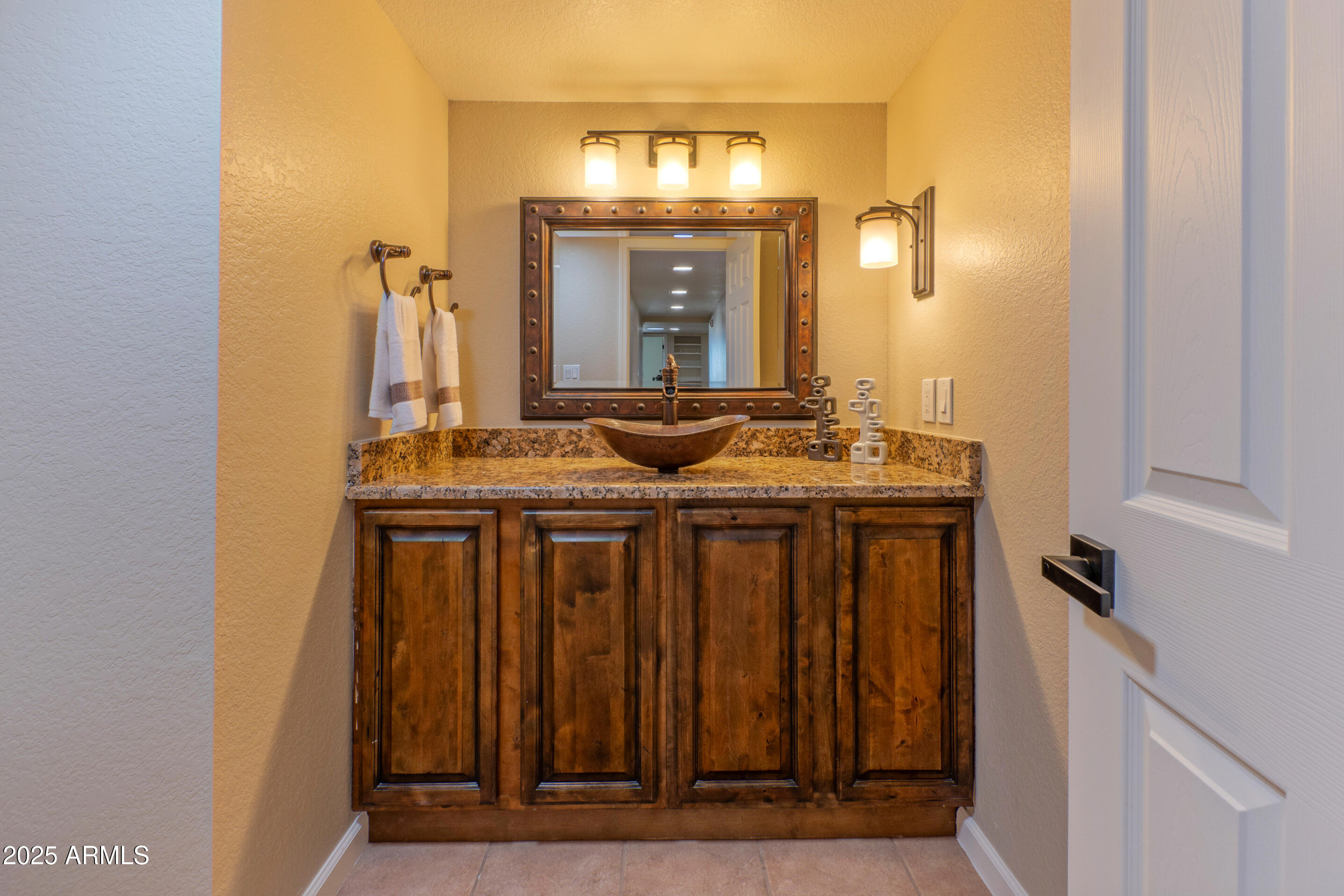 5911 East Peak View Road Cave Creek, AZ 85331 - Photo 22 of 63 a bathroom with a granite countertop sink and a mirror