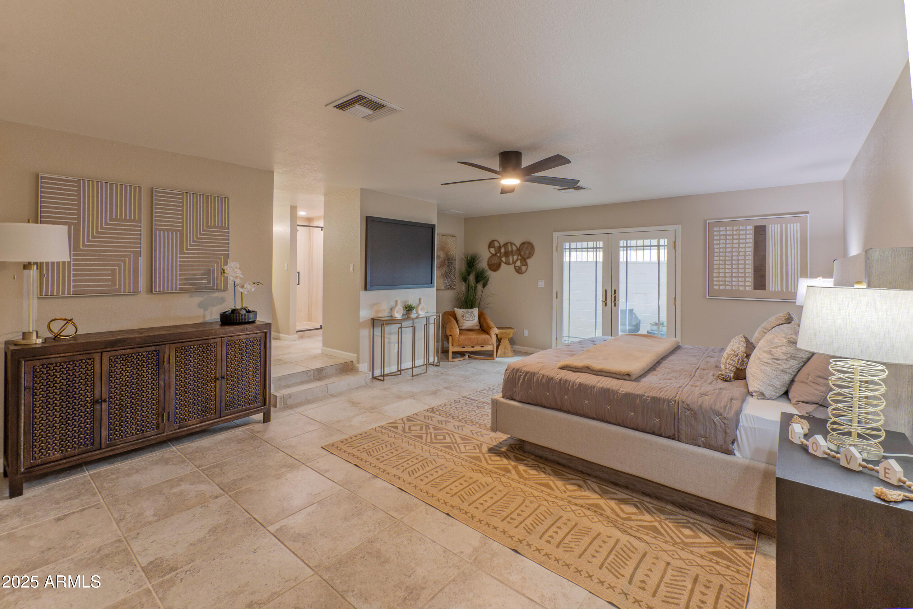 5911 East Peak View Road Cave Creek, AZ 85331 - Photo 23 of 63 a spacious bedroom with a bed a dresser and windows