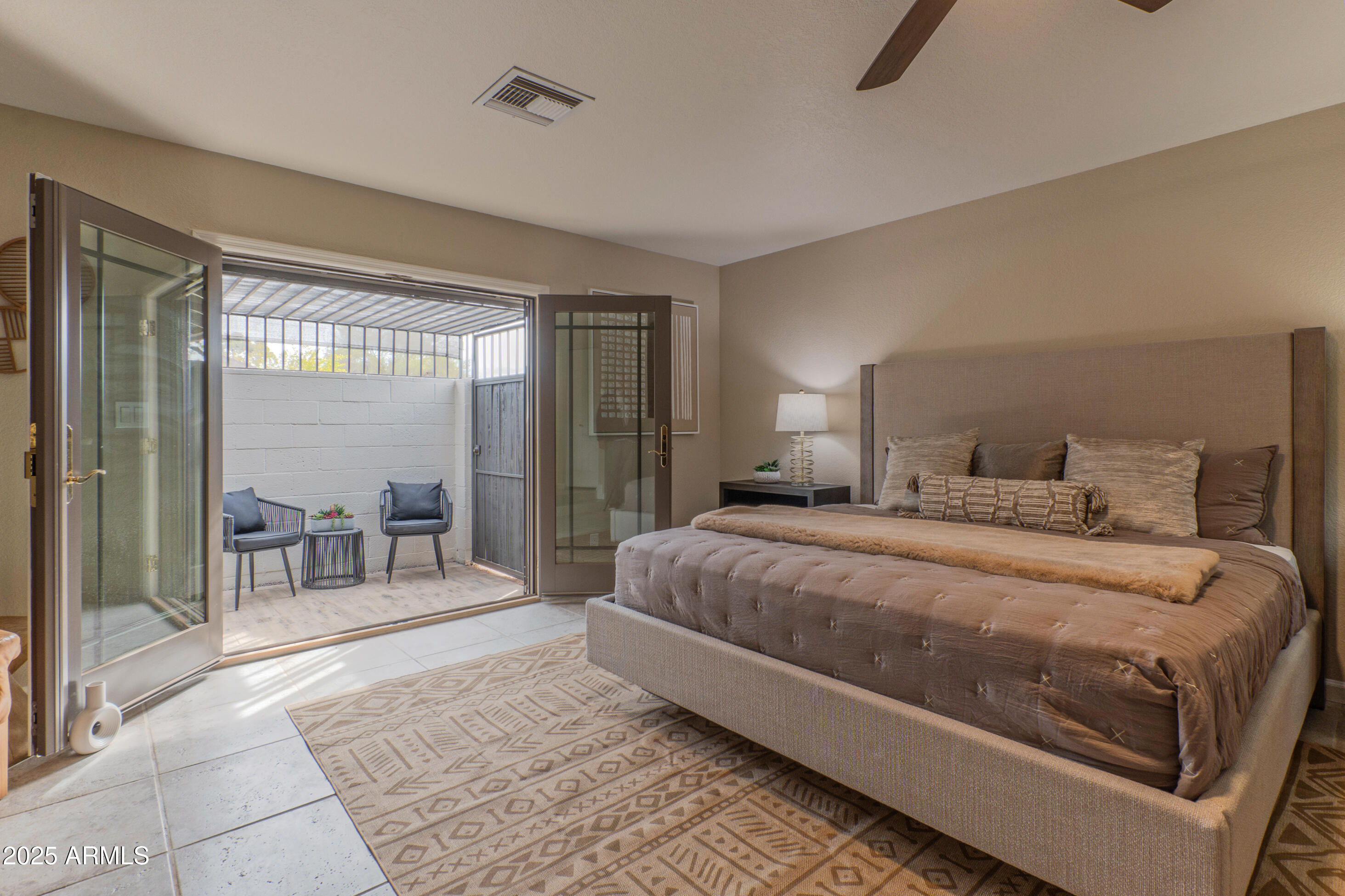 5911 East Peak View Road Cave Creek, AZ 85331 - Photo 25 of 63 a bedroom with a large bed and a large window