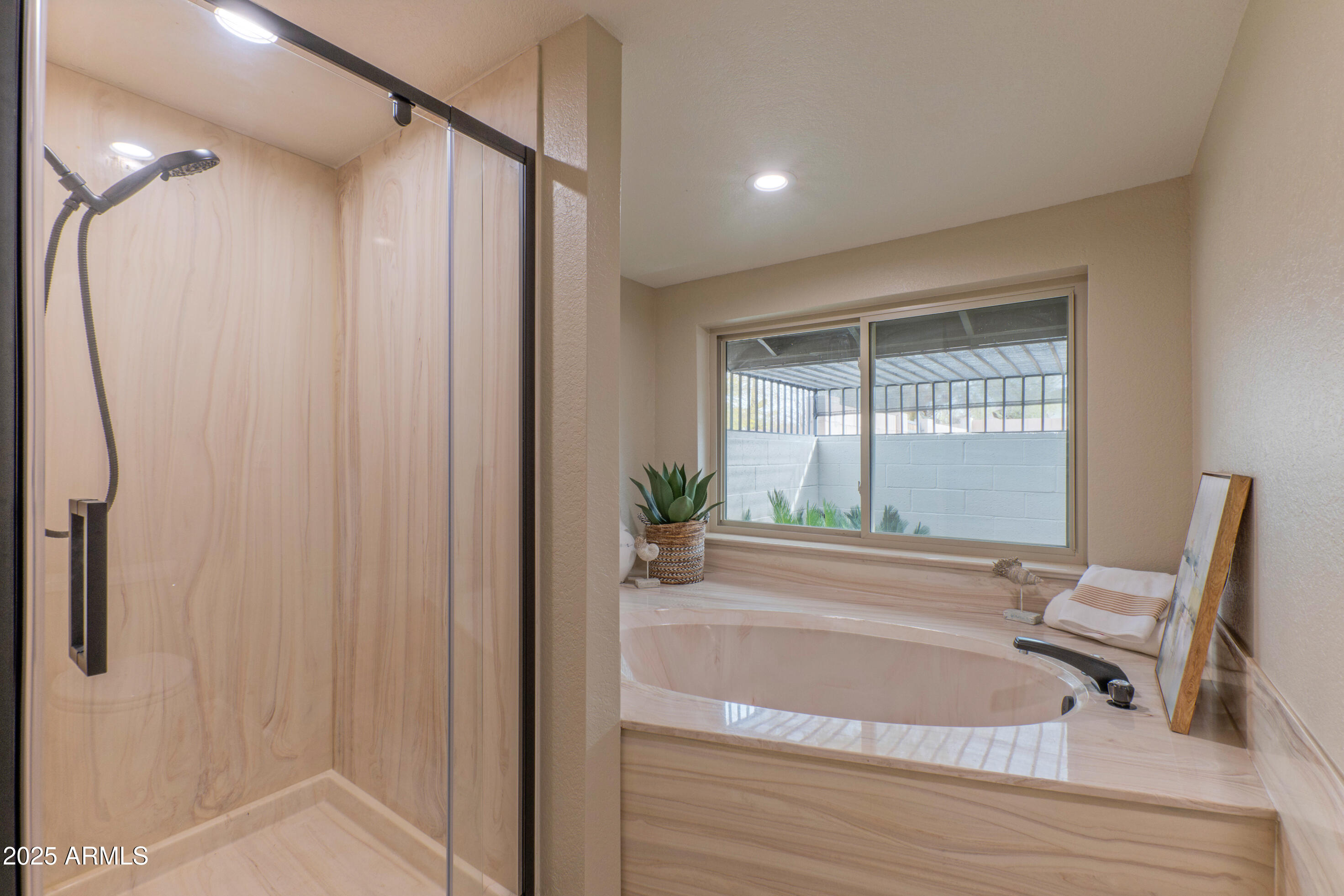 5911 East Peak View Road Cave Creek, AZ 85331 - Photo 28 of 63 a bathroom with a bathtub a sink and a window