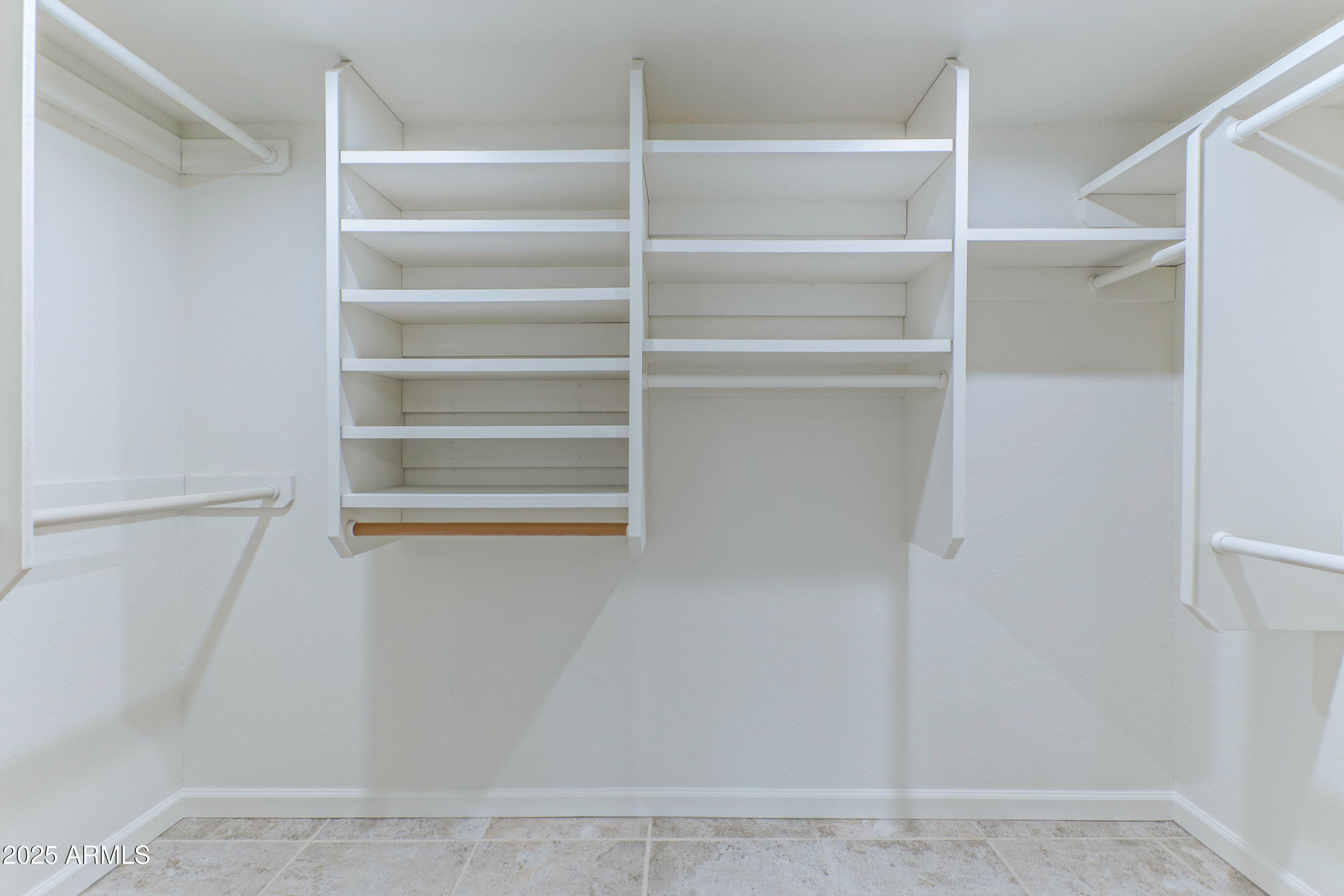 5911 East Peak View Road Cave Creek, AZ 85331 - Photo 29 of 63 a view of walk in closet with empty racks