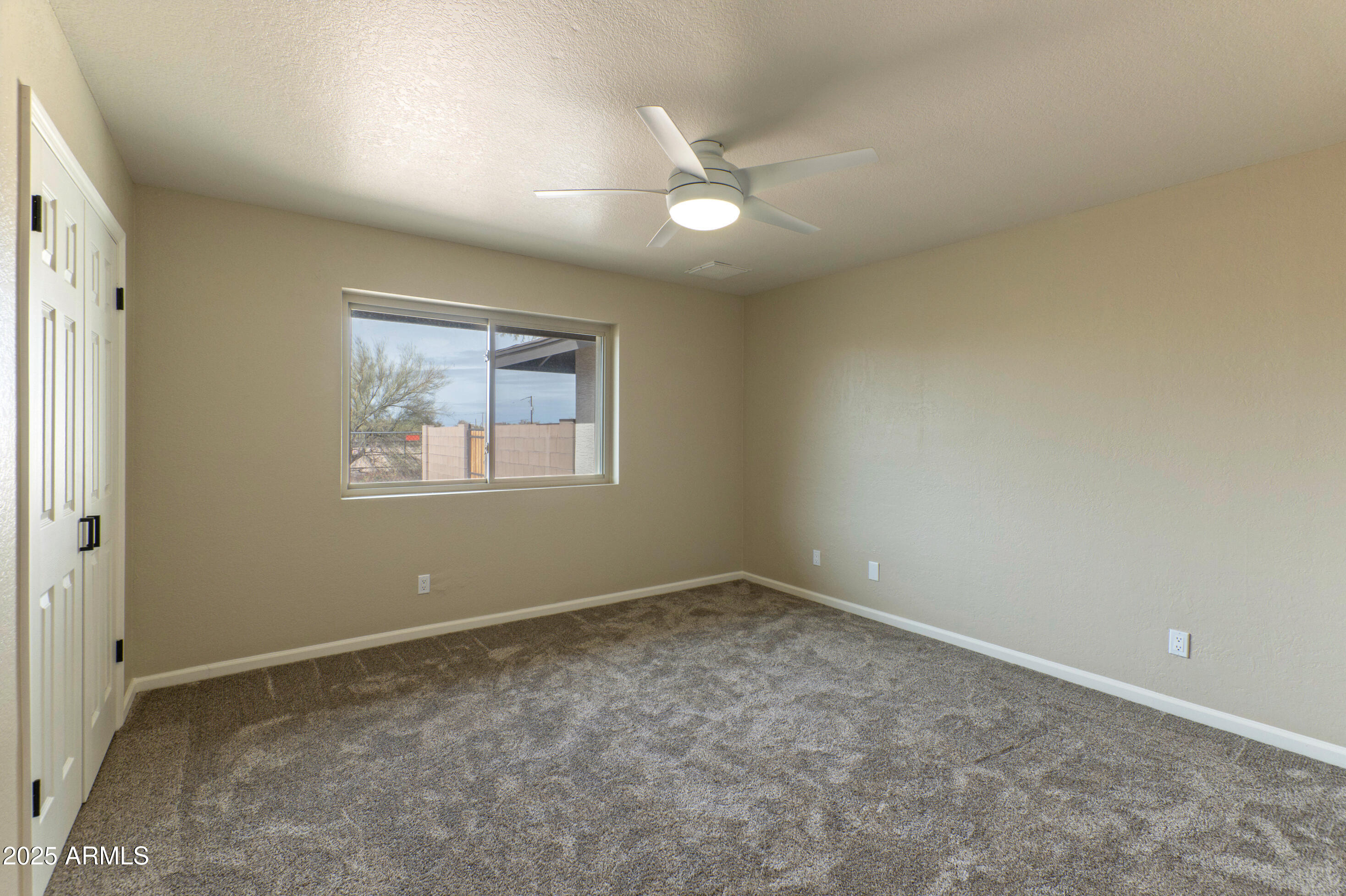 5911 East Peak View Road Cave Creek, AZ 85331 - Photo 32 of 63 a view of an empty room with a window