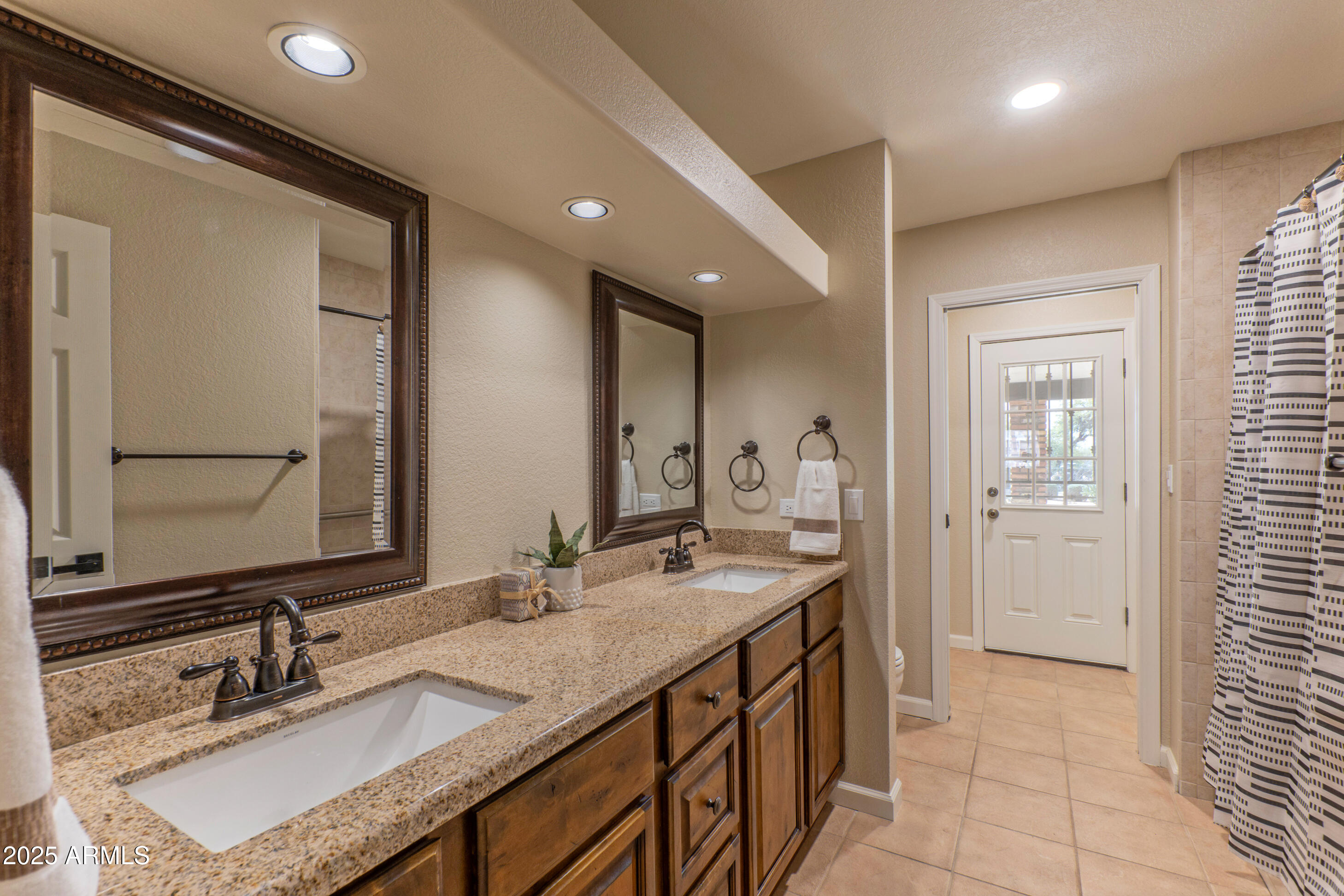 5911 East Peak View Road Cave Creek, AZ 85331 - Photo 33 of 63 a bathroom with a granite countertop sink and a mirror