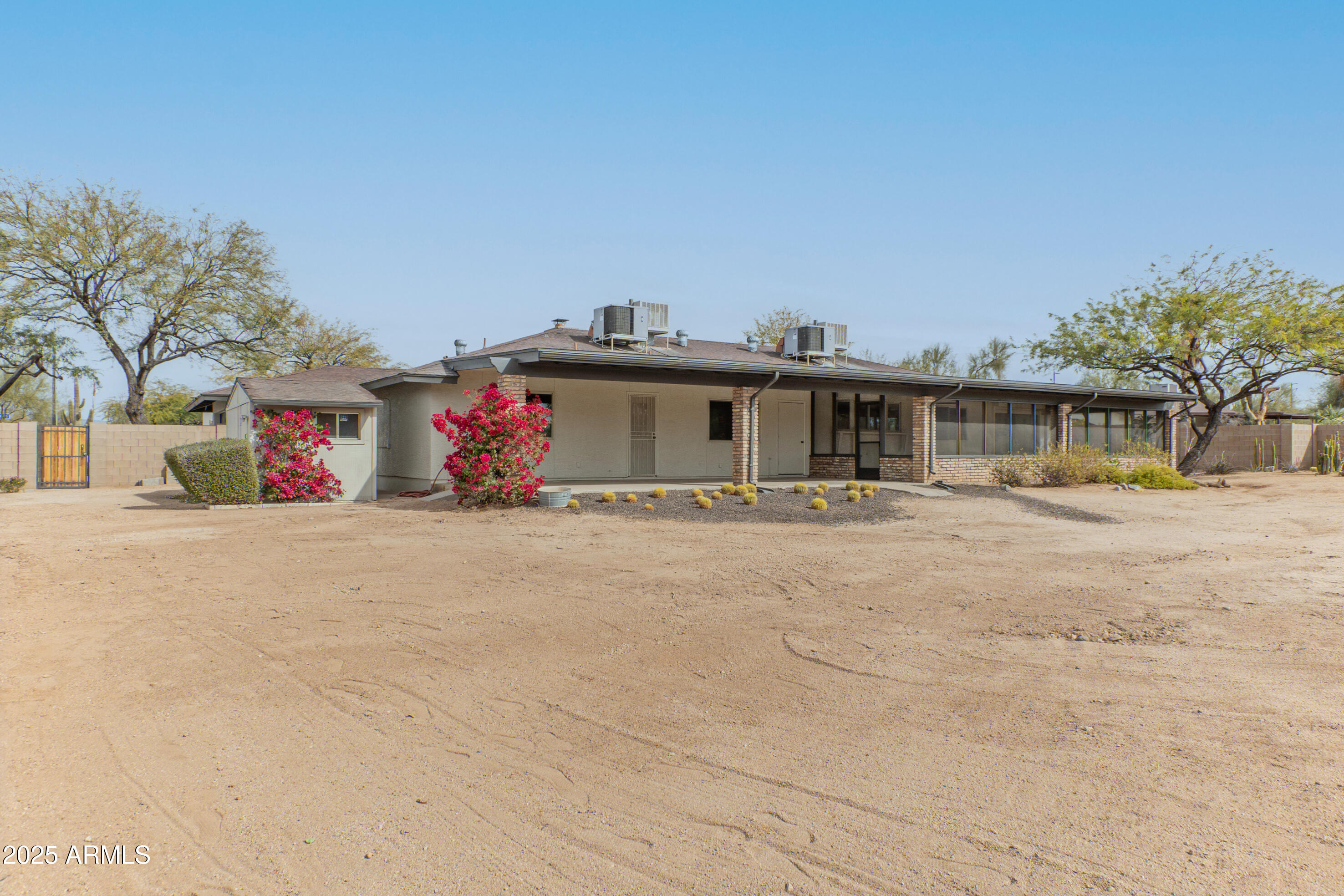 5911 East Peak View Road Cave Creek, AZ 85331 - Photo 40 of 63 a front view of a house with a snow on the road