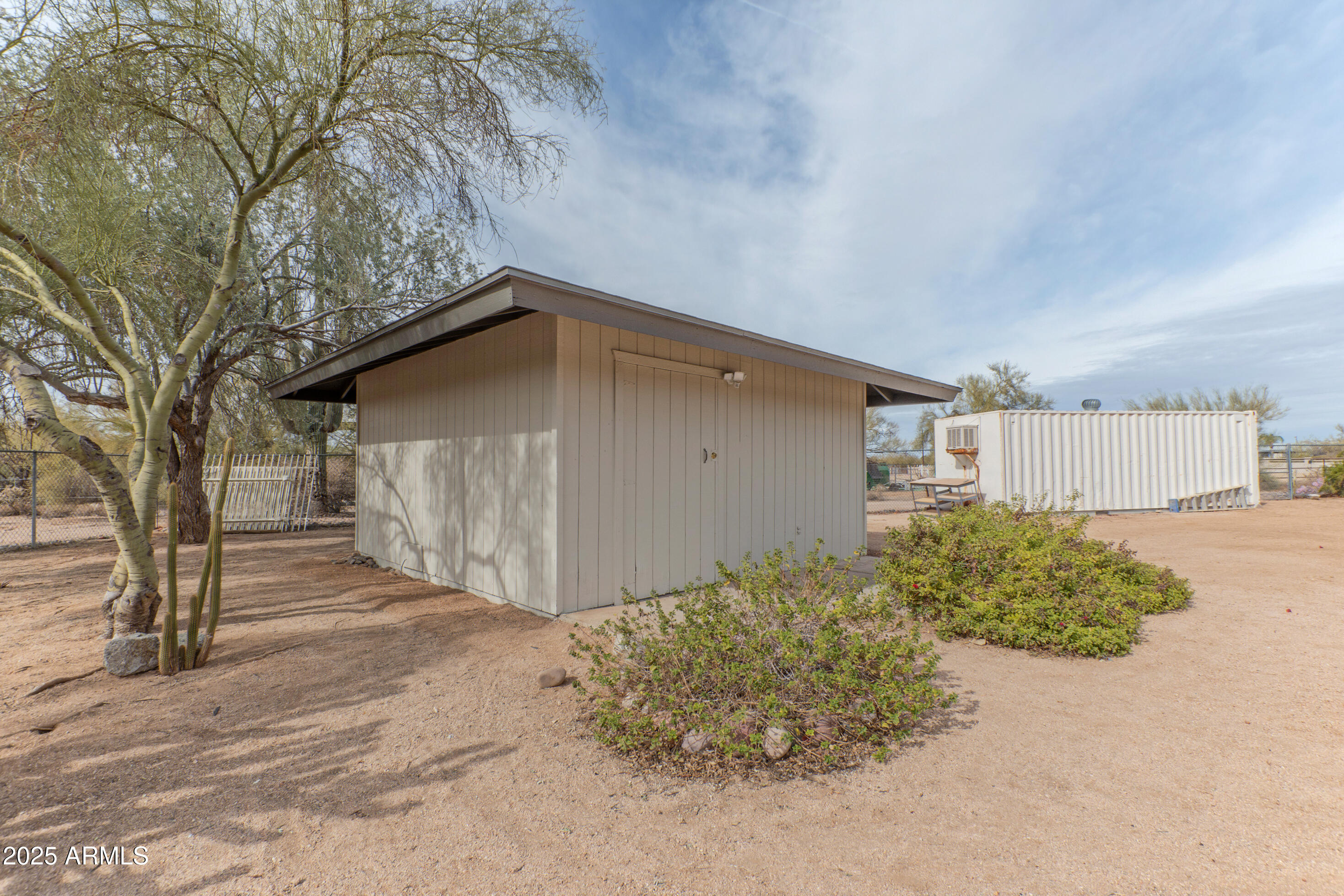 5911 East Peak View Road Cave Creek, AZ 85331 - Photo 46 of 63 a backyard of a house with large trees and plants