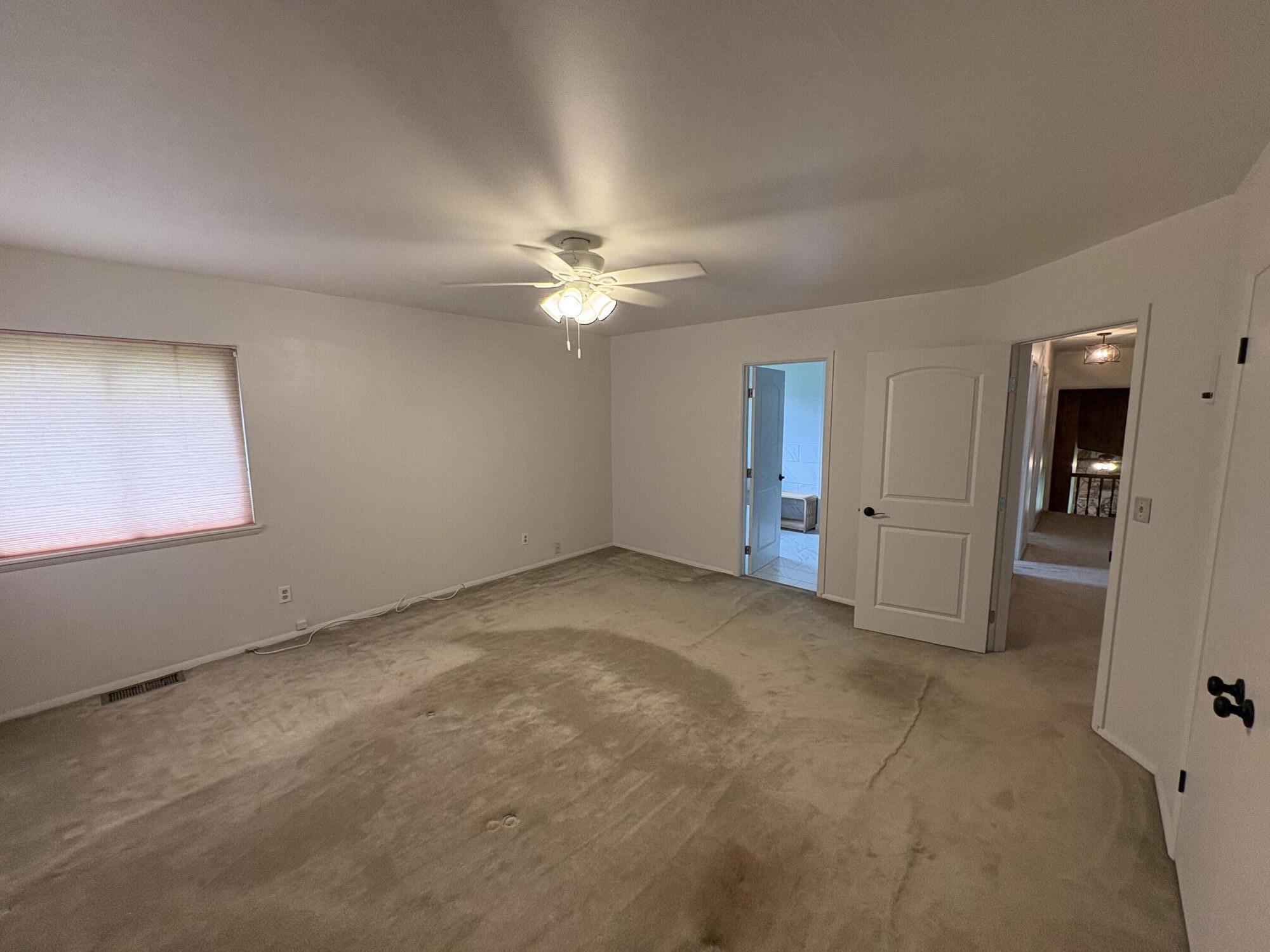 41139 Brown Road Fall River Mills, CA 96028 - Photo 24 of 29 an empty room with chandelier fan and windows