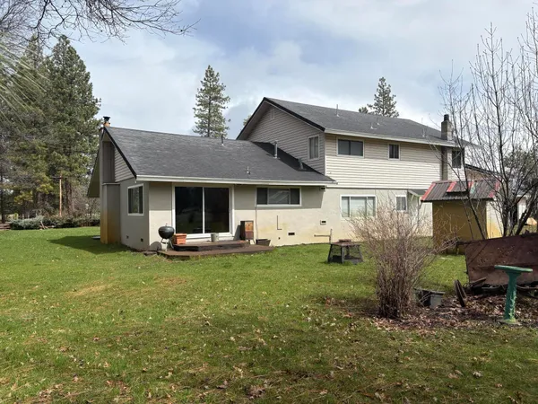a view of a house with backyard porch and sitting area