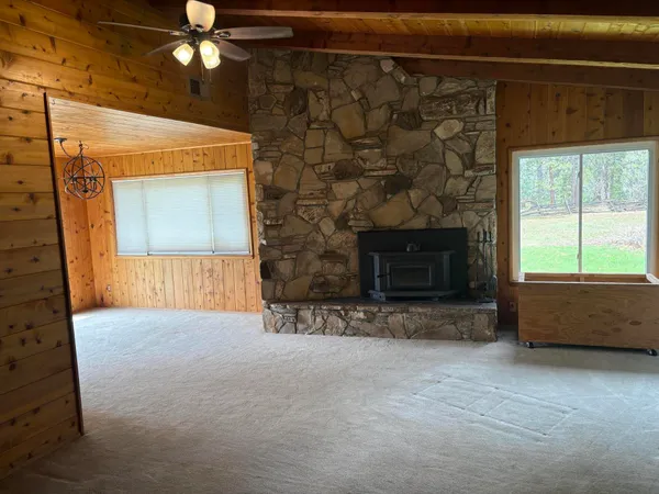 a view of empty room with a fireplace
