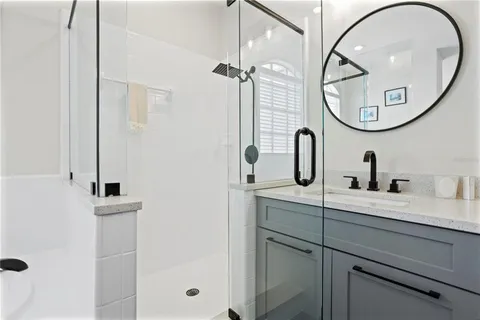 a bathroom with a sink a mirror a vanity and a mirror