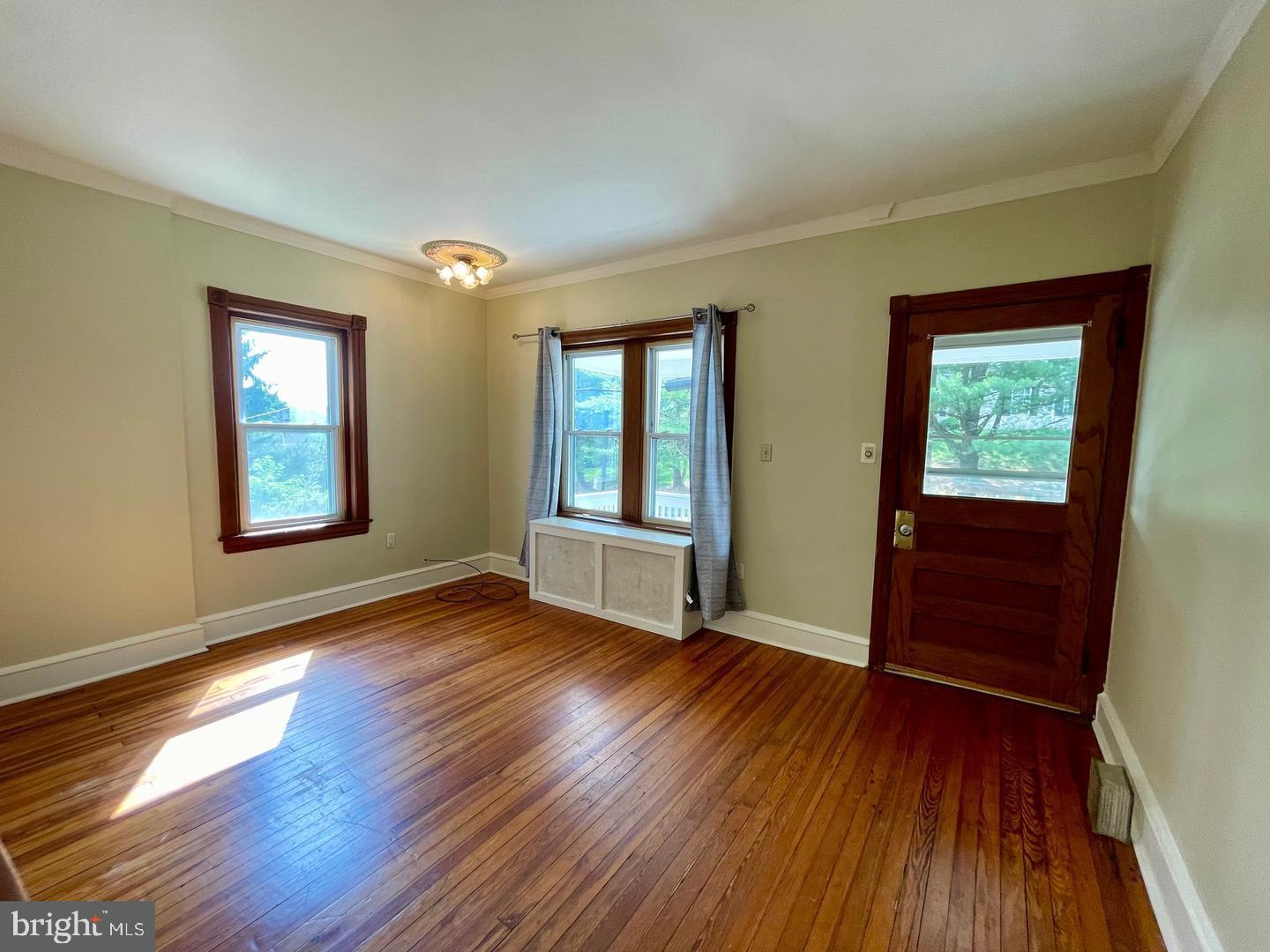 692 Lenni Road Aston, PA 19014 - Photo 4 of 28 a view of an empty room with wooden floor and a window