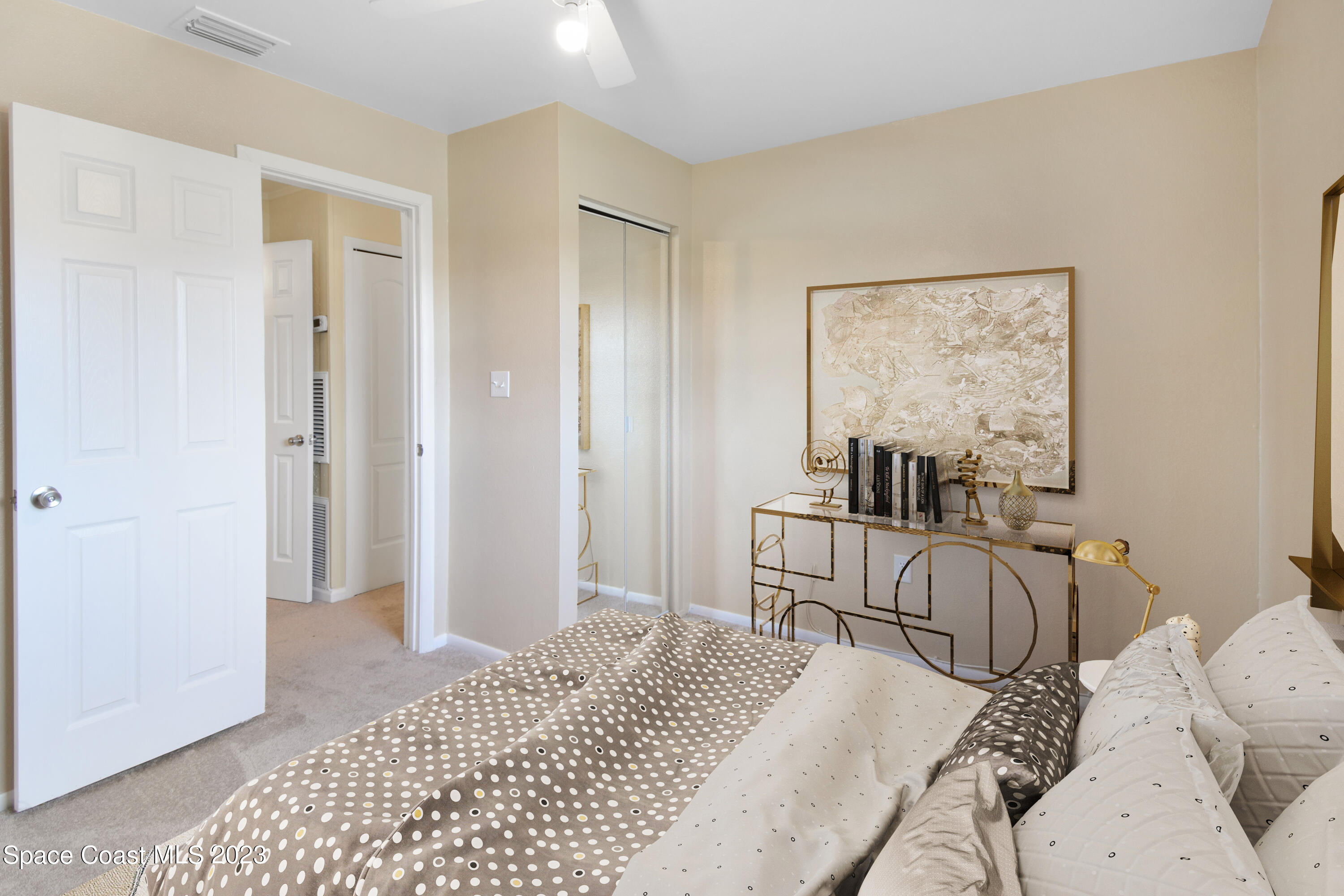 2439 Delaware Drive Melbourne, FL 32935 - Photo 11 of 32 a bedroom with a bed and a couch