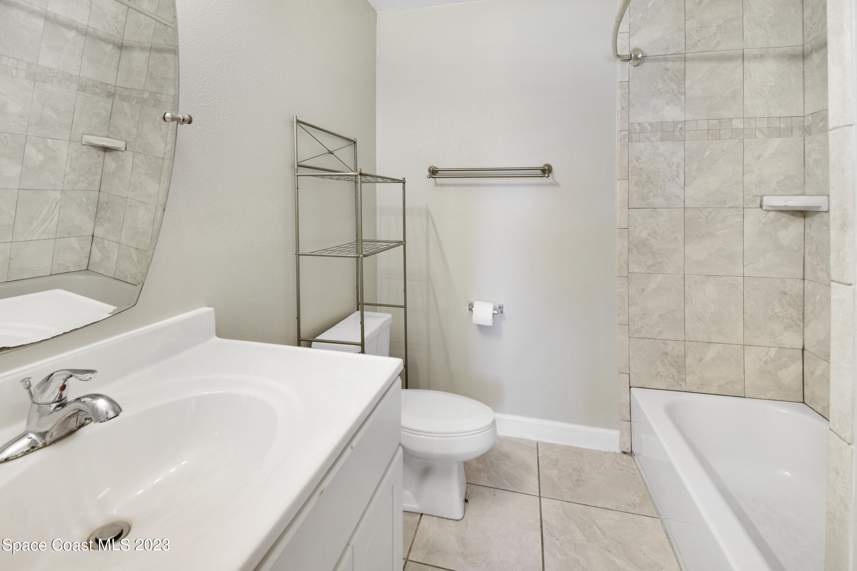 2439 Delaware Drive Melbourne, FL 32935 - Photo 16 of 32 a bathroom with a sink toilet and shower