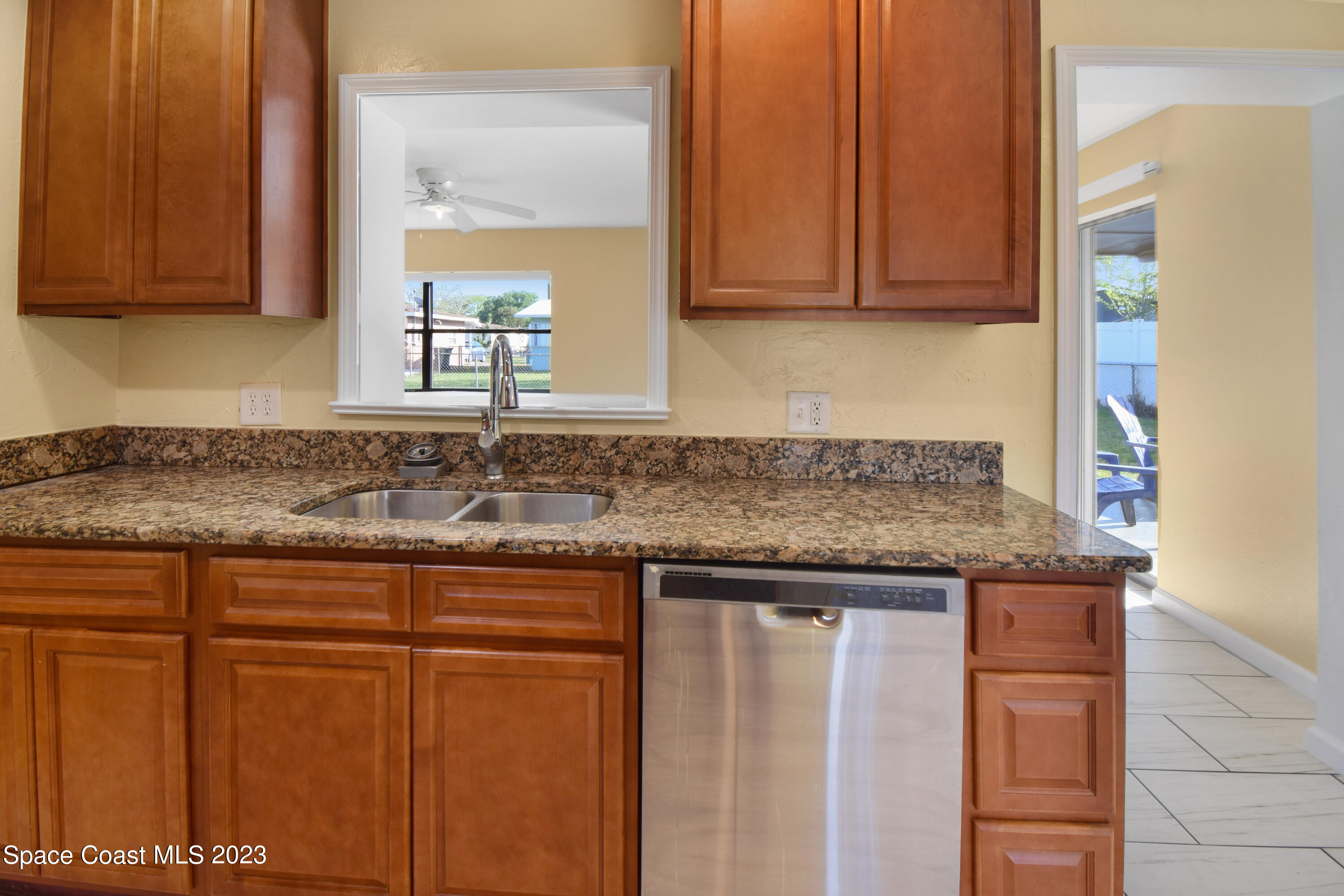 2439 Delaware Drive Melbourne, FL 32935 - Photo 19 of 32 a kitchen with granite countertop cabinets sink and stove