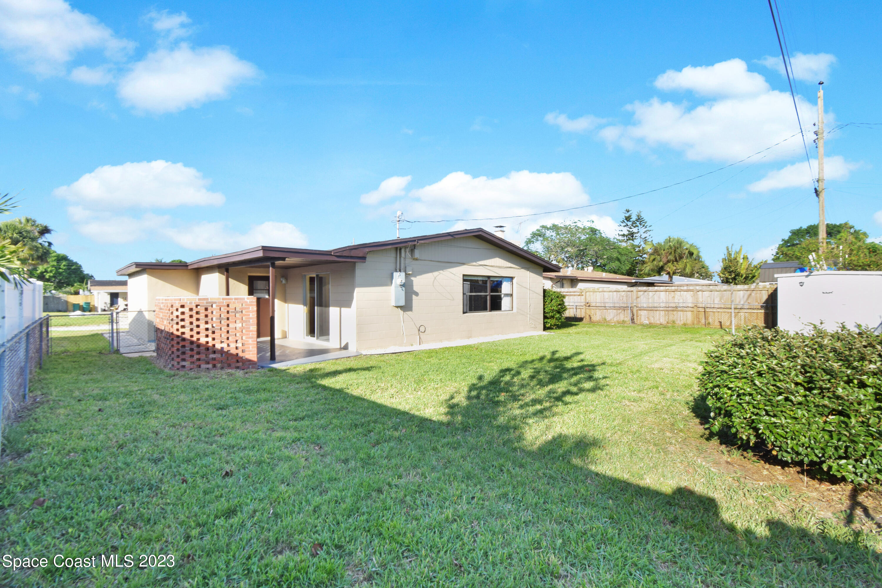 2439 Delaware Drive Melbourne, FL 32935 - Photo 25 of 32 a front view of a house with garden