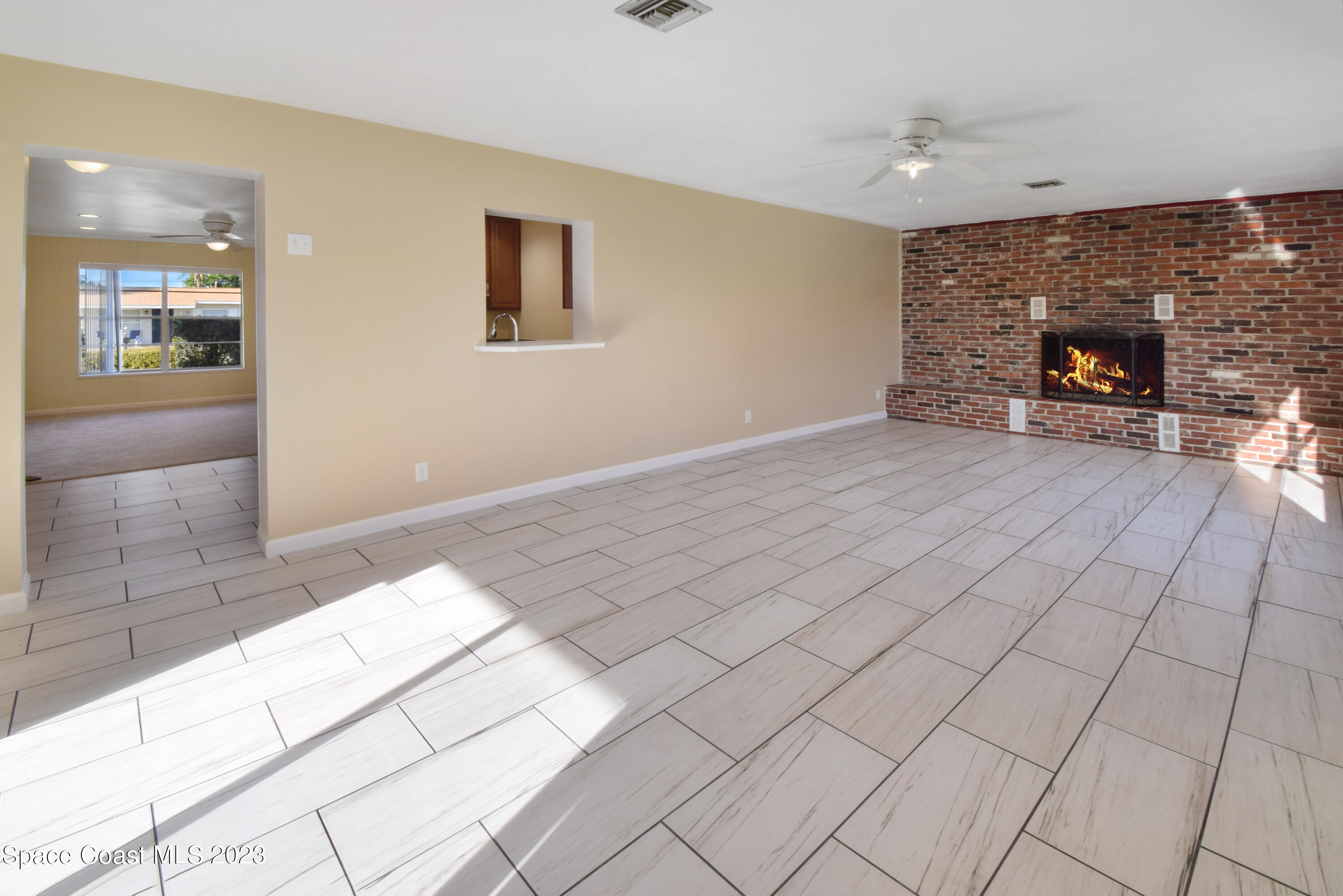 2439 Delaware Drive Melbourne, FL 32935 - Photo 4 of 32 a view of a livingroom with furniture and a fireplace