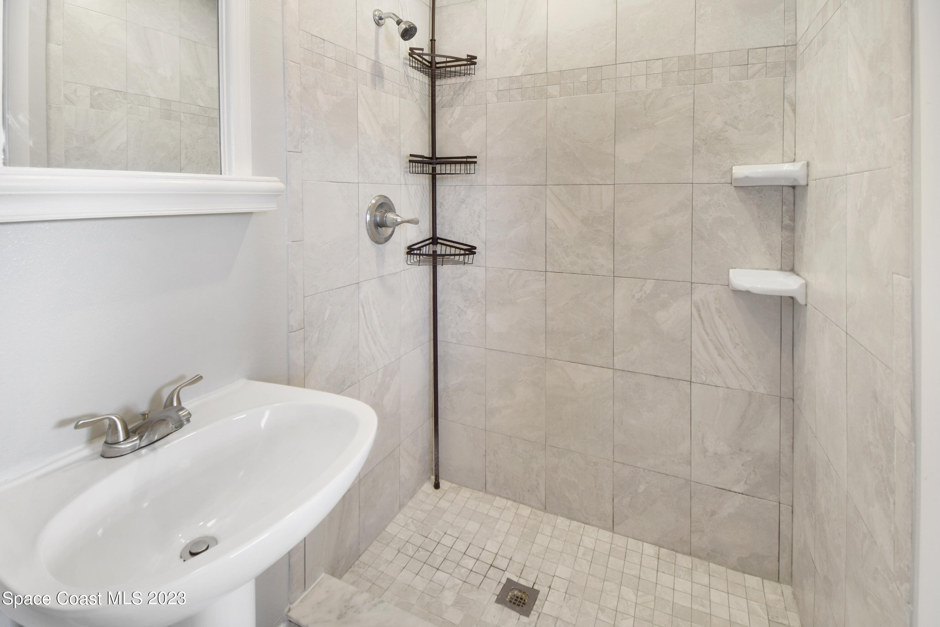 2439 Delaware Drive Melbourne, FL 32935 - Photo 8 of 32 a bathroom with a sink and a window