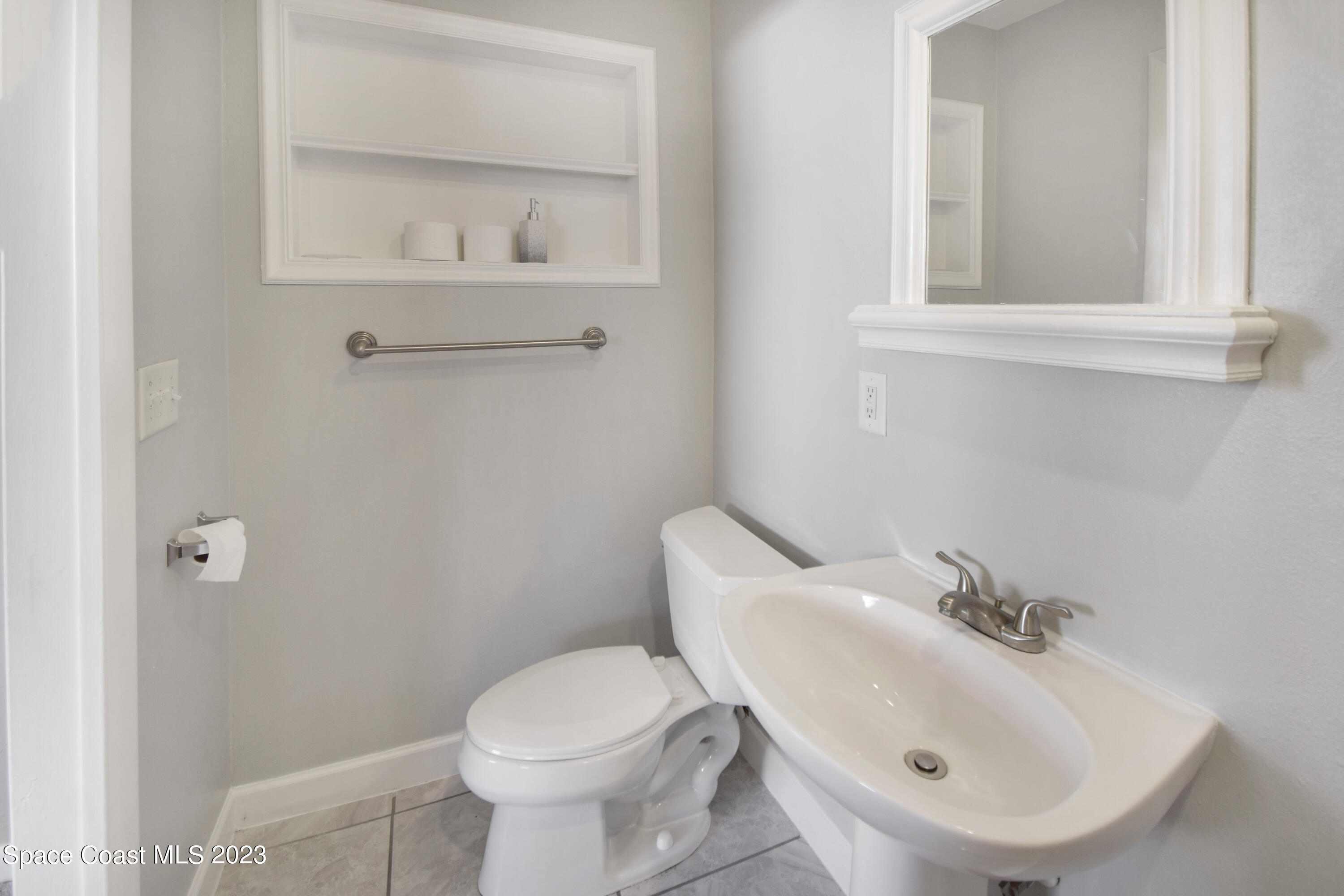 2439 Delaware Drive Melbourne, FL 32935 - Photo 9 of 32 a bathroom with a sink and a toilet