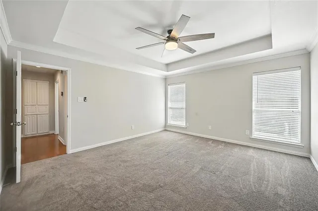 an empty room with fan and windows