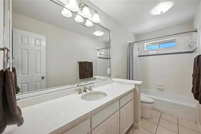 a bathroom with a sink a large mirror and a toilet