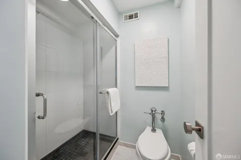 a bathroom with a toilet sink and shower