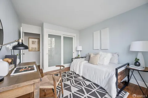 a bedroom with a bed and a lamp on table